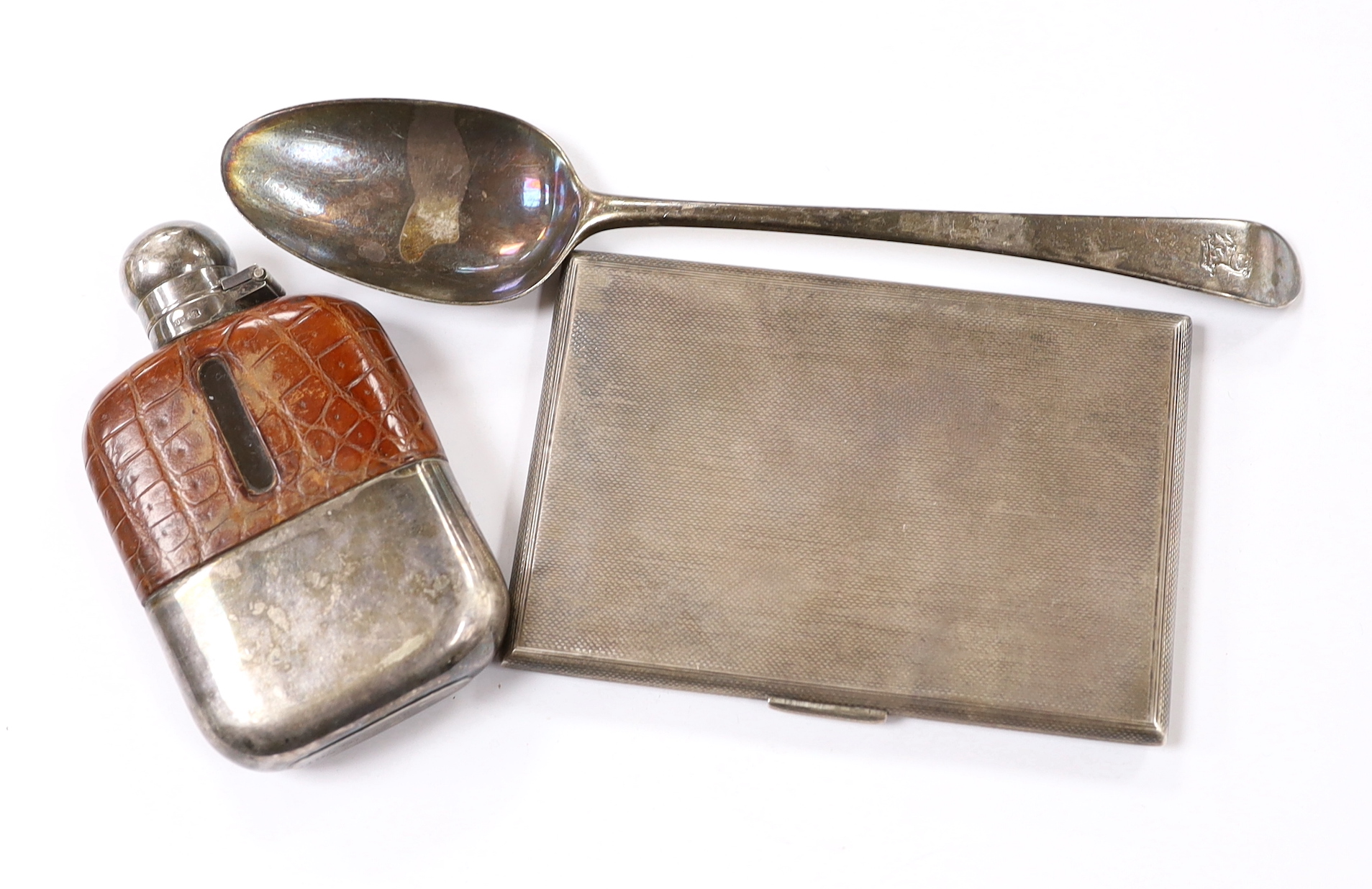 A George VI engine turned silver rectangular cigarette case by Asprey & Co, London, 1942, 12.5cm, together with an 18th century silver base mark table spoon and silver plated and leather mounted hip flask.